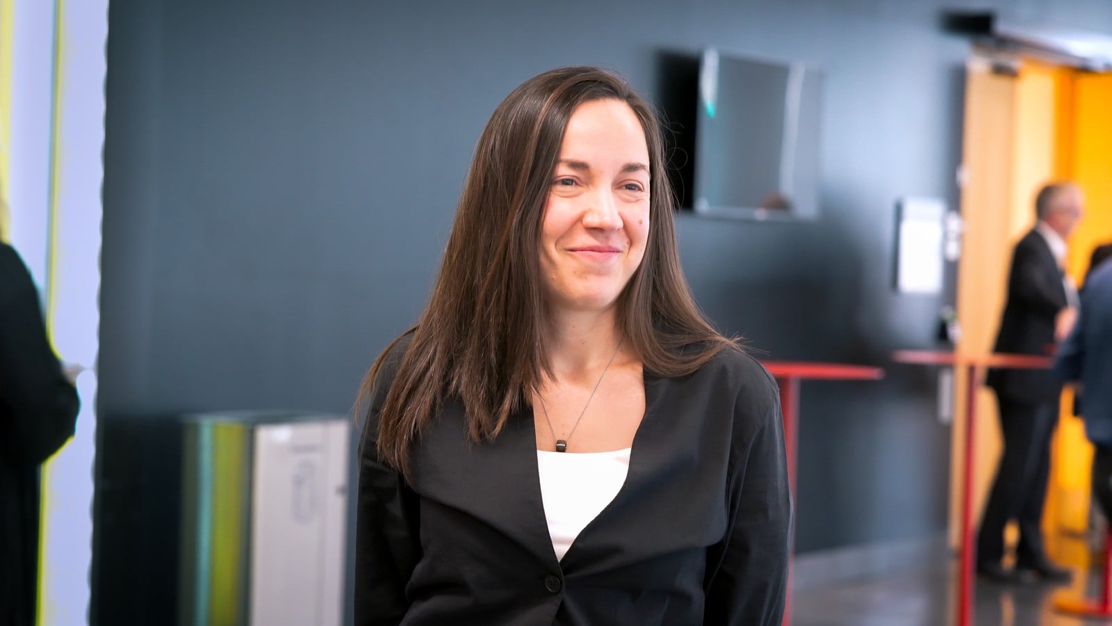 Dimitra Panteli standing in front of a group of people.